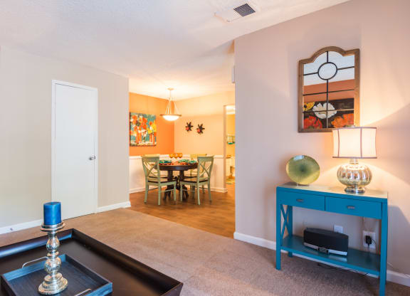 a living room with a blue cabinet and a dining room table at Dunwoody Pointe in Sandy Springs, GA
