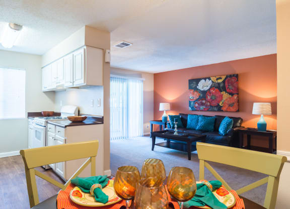 a living room with a dining room table and a kitchen at Dunwoody Pointe in Sandy Springs, GA