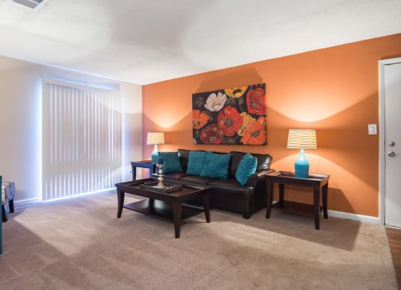 a living room with a couch and a table at Dunwoody Pointe in Sandy Springs, GA