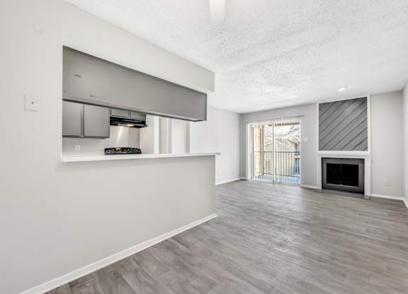 A spacious living room with a fireplace and sliding glass doors.