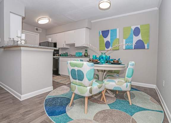 A cypress dining room with a table and chairs in the middle of the room at The Marq in Shreveport, LA