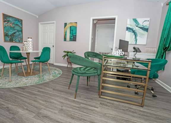 Leasing office interior with chairs and a glass desk at The Marq apartments in Shreveport, LA
