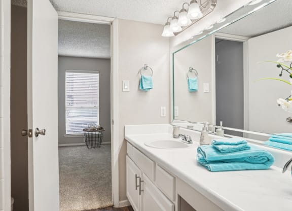 Model A2 floor plan bathroom with a sink and a mirror Noel on The Parkway in Dallas, TX