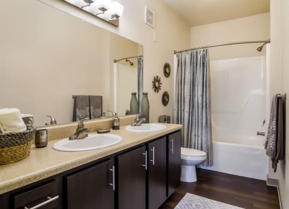 Bathroom with two sinks and a shower at Oakleaf Plantation in Jacksonville, FL