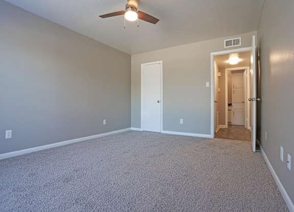 A bedroom with a ceiling fan and closet at Orleans Square in Shreveport, LA