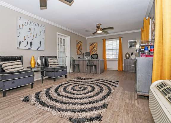 A leasing office with a black and white rug and a ceiling fan at Orleans Square in Shreveport, LA
