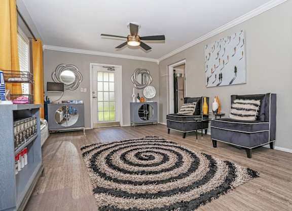 A leasing office with a black and white rug and a ceiling fan at Orleans Square in Shreveport, LA