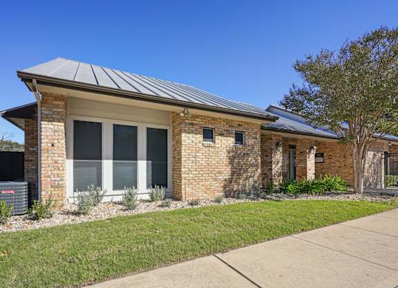 Side shot of our leasing office at On the Green apartments in Austin, TX