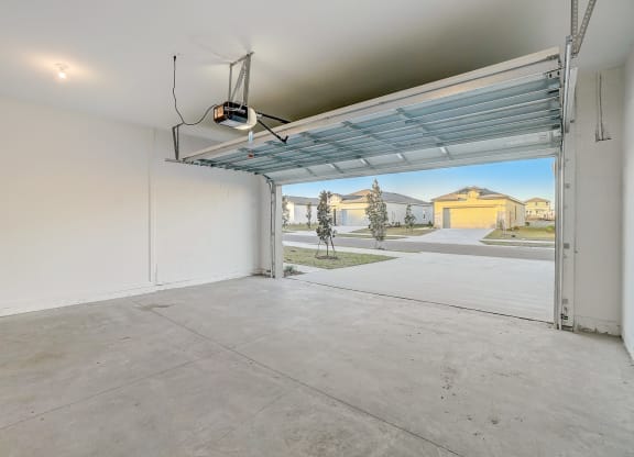 the interior of a garage with an open garage door