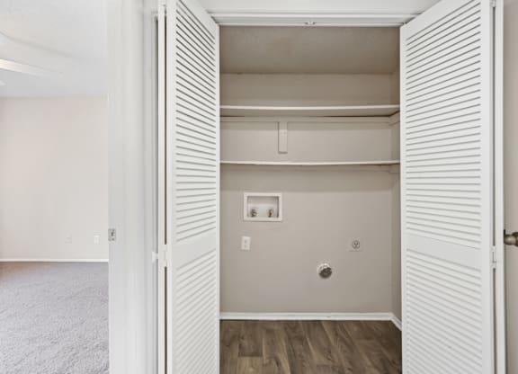 a bedroom with a medium sized closet and hardwood floors