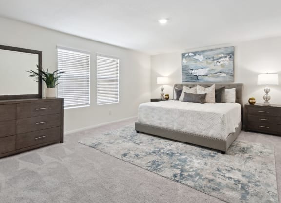 a bedroom with a bed and two dressers