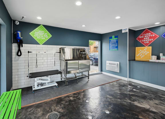 a kitchenette with a bar and a green bench in front of a door