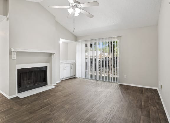 a living room with a fireplace and a large window