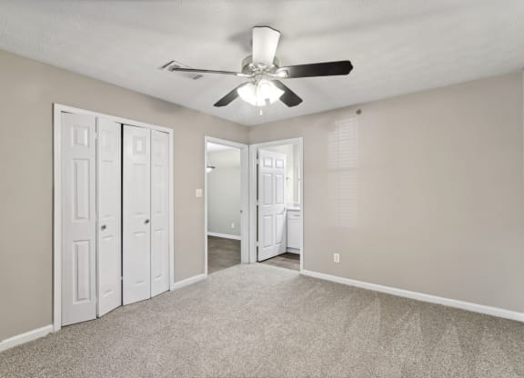 Unfurnished bedroom with closet and ceiling fan at Oakley Run apartments in Smyrna, GA