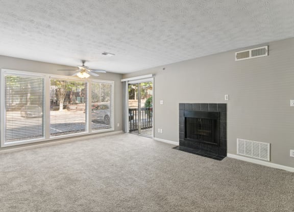 Bright living room with a fireplace and a ceiling fan at Oakley Run apartments in Smyrna, GA