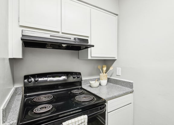 Modern and fully-equipped kitchen area at Pine Village North in Smyrna, GA