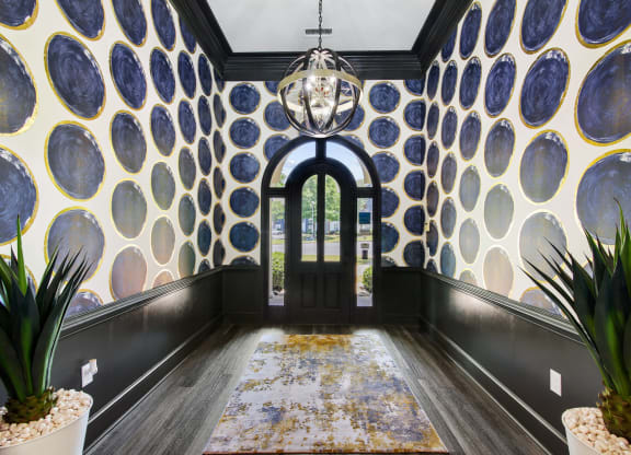 a hallway with plants at Grand Reserve at Columbus Apartments in Columbus, Georgia, GA