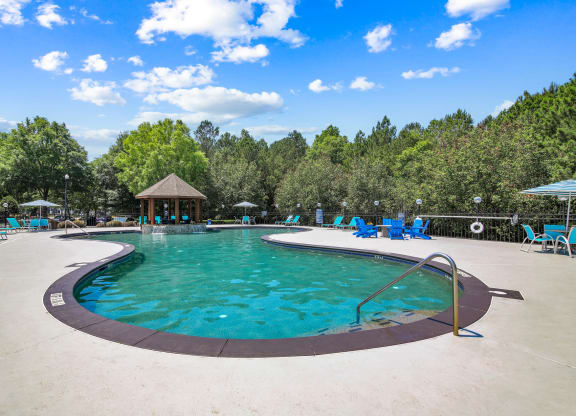 a resort style pool with chaise lounge chairs and a gazebo at Grand Reserve at Columbus Apartments in Columbus, Georgia, GA