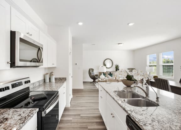 a kitchen with white cabinets and granite countertops