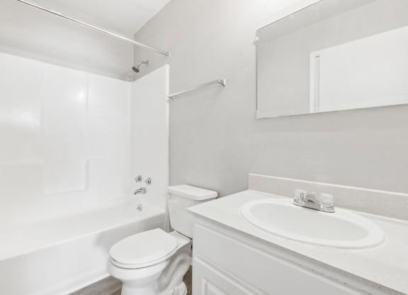 Bathroom with shower, sink and toilet in B1 floor plan at Riverwood Crossing apartments in Roswell, GA.