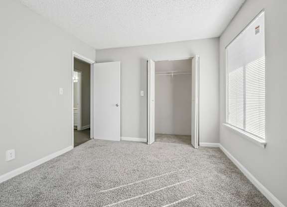 Second bedroom view of closet and entrance in C2b floor plan at Riverwood Crossing apartments in Roswell, GA.
