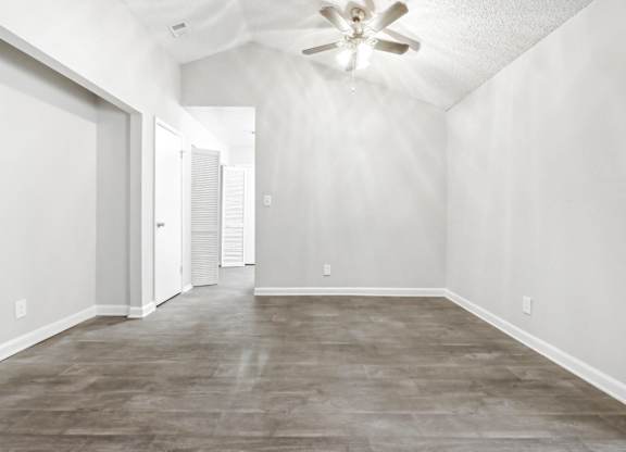 Large dining room with vaulted ceiling and ceiling fan in C2b floor plan at Riverwood Crossing apartments in Roswell, GA.