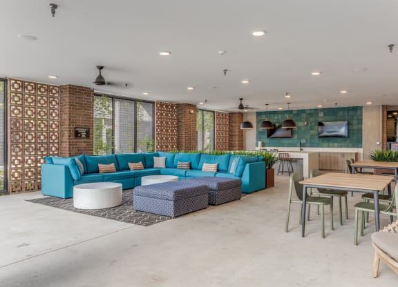 Outdoor lounge with couch and chairs at St. Elmo Apartment in Austin, TX
