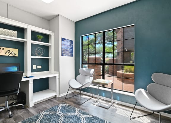 a room with a large window and two chairs