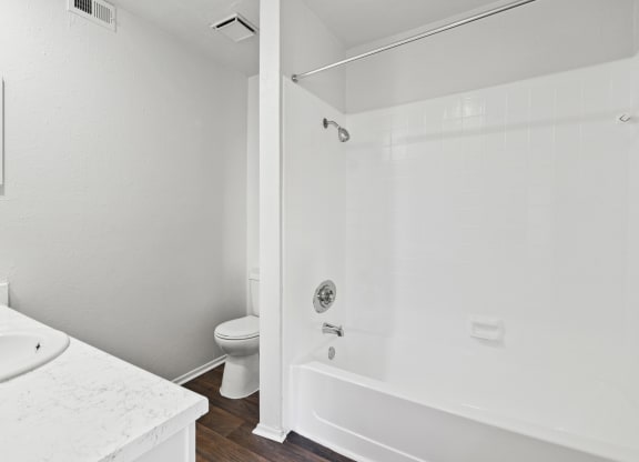 a bathroom with a toilet sink and shower