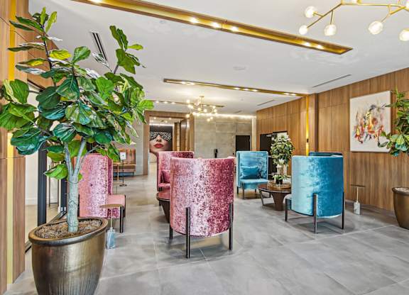 Lobby room with pink and blue chairs at Twenty2 West luxury apartments in Miami, FL.