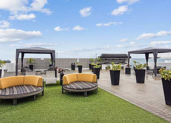 Beautiful sundeck with shaded and open seating at Twenty2 West luxury apartments in Miami, FL