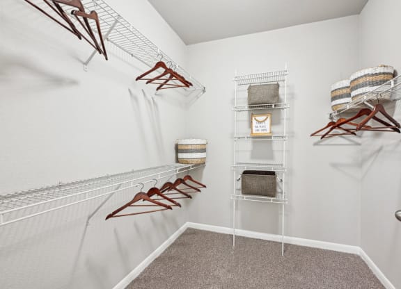 Walk-in closet with ample storage space at The Grand at Upper Kirby apartments in Houston, TX