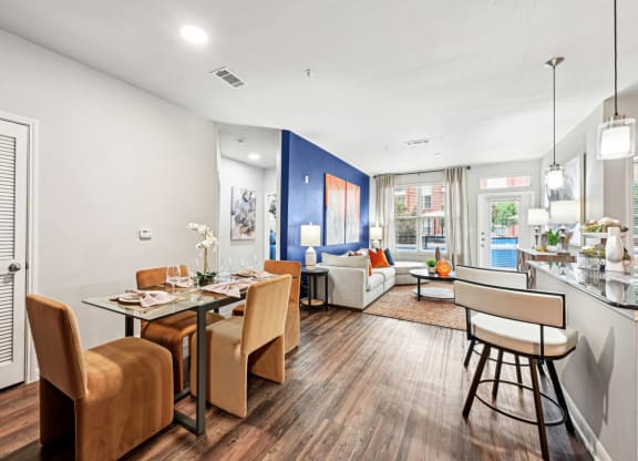 Dining area and living room with modern decor at The Grand at Upper Kirby apartments in Houston, TX