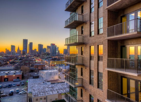 Exterior view of apartment building facing skyline of deep ellum