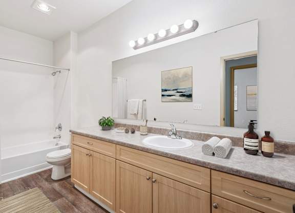 Master bathroom for Jackson floor plan with large vanity, toilet and shower at The Madison apartments in Olympia, WA