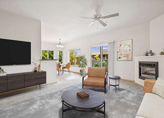 Virtually staged living room with a fireplace in the Jackson floor plan at The Madison apartments in Olympia, WA.