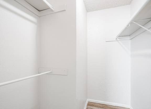 A1 white closet with a shelf and a vent at Vine Apartments in Arlington, TX