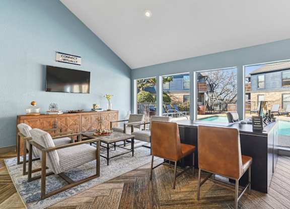 A leasing office with chairs and a large window at Vine Apartments in Arlington, TX