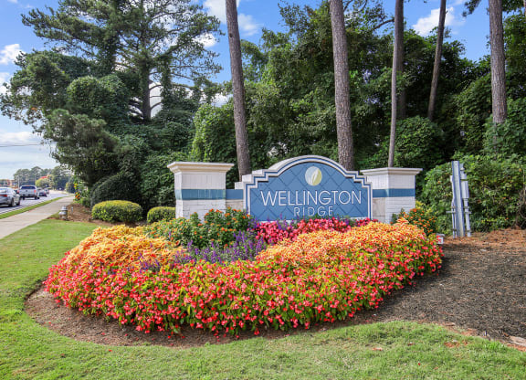 Property sign in bed of flowers at Wellington Ridge in Lawrenceville, GA