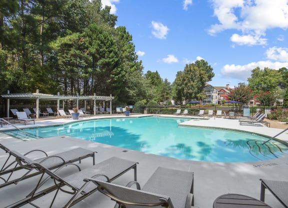 Beautiful swimming pool with poolside lounge chairs at Wellington Ridge apartments in Lawrenceville, GA