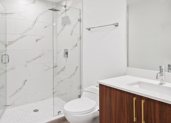 a bathroom with a toilet sink and shower
