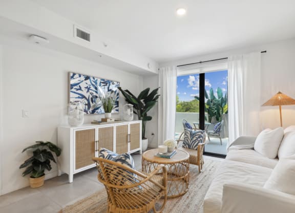Living Room with entertainment center and white couch in B1 Floor Plan at Westgate on University in Lauderhill, FL