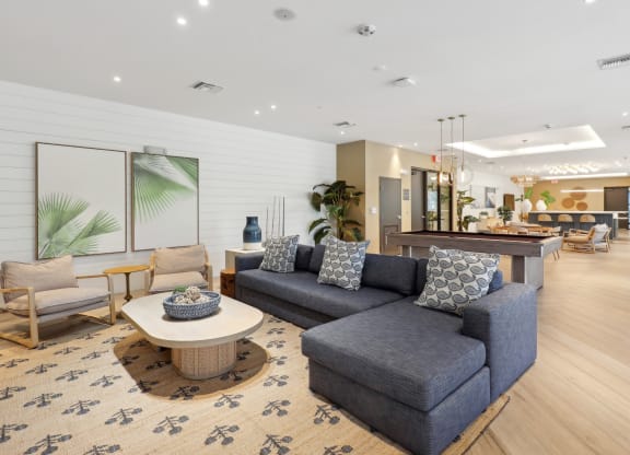 Resident Social and Gaming Lounge with L-shaped couch at Westgate on University in Lauderhill, FL