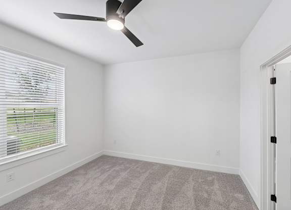 B2 bedroom with a ceiling fan and a door at Whispering Pines at Westdale Hills in Euless, TX
