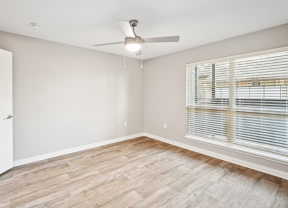 Cozy bedroom area in the D5 floor plan at Windridge On The Parkway Apartments in Dallas, TX