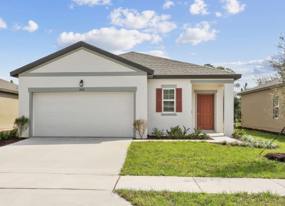 a home with a white house and a brown door at Beacon at Woodland Village, Florida, 32724