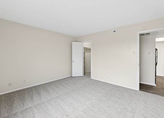 A2 bedroom with carpet and door at Westdale Pointe in Austin, TX