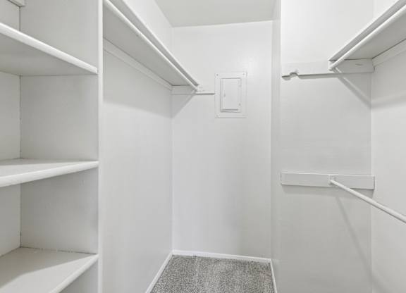 A2 walk-in closet with built-in shelves and hanging rods at Westdale Pointe in Austin, TX