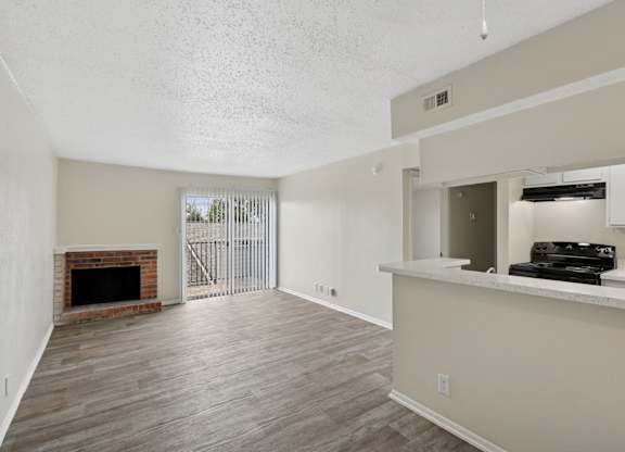 A2 living room with fireplace and sliding door at Westdale Pointe in Austin, TX