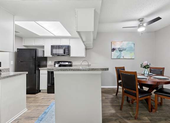 B1 kitchen and dining area with a table and chairs at Westdale Pointe in Austin, TX
